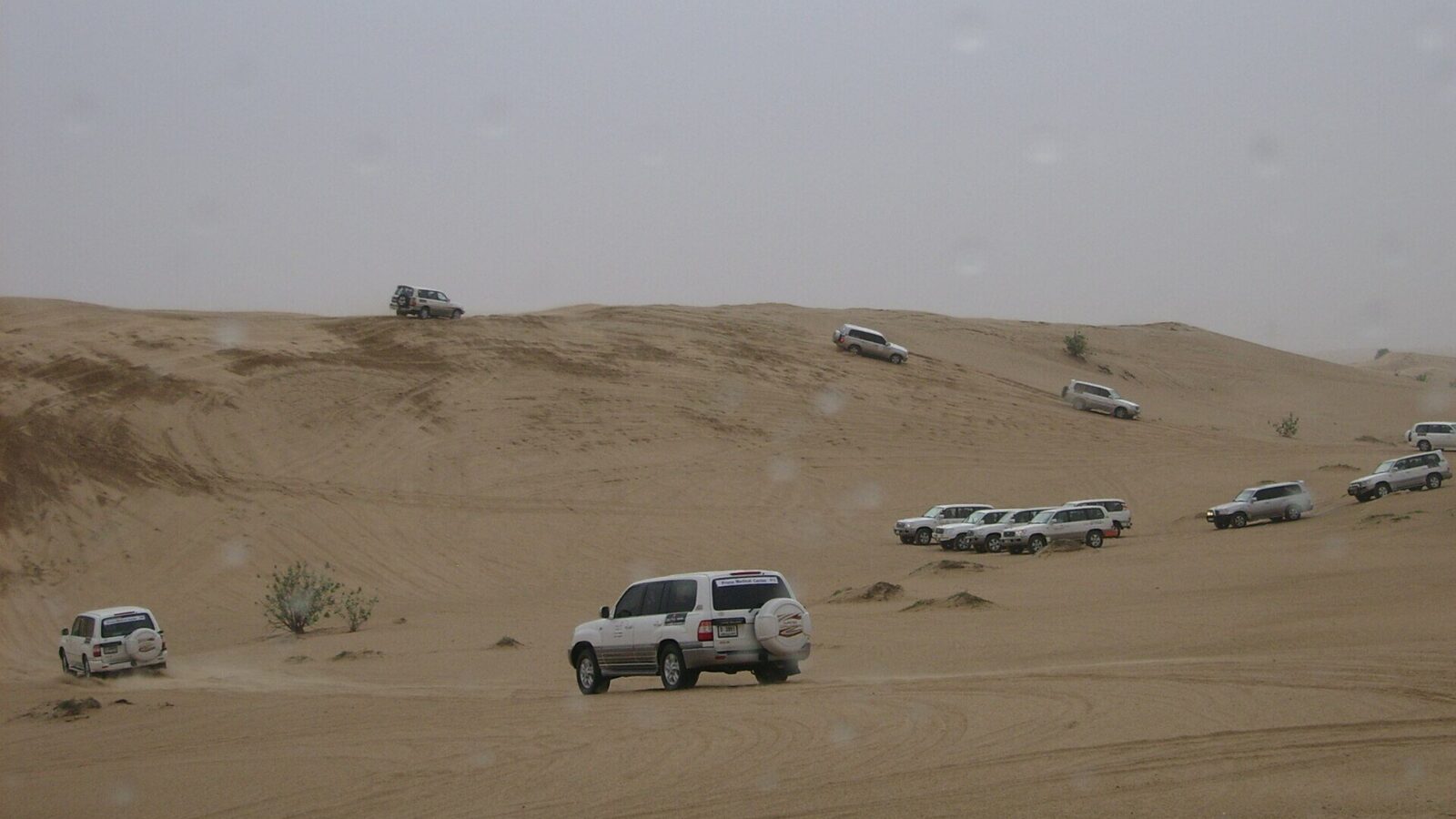 A 4x4 driving over desert dunes
